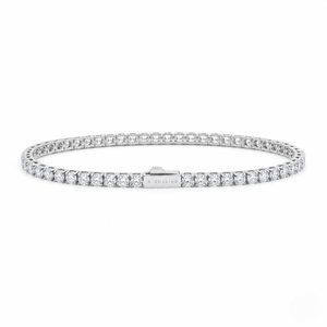 A silver tennis bracelet paved with clear round stones, featuring a central clasp engraved with the brand name 'J. COLLINS', set against a plain white background - J.Collins Jewelry
