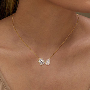 Gold Toi et Moi Emerald-Cut and Pear-Cut Diamond Double Halo Pendant Necklace Worn on Female Décolletage - J. Collins Jewelry 