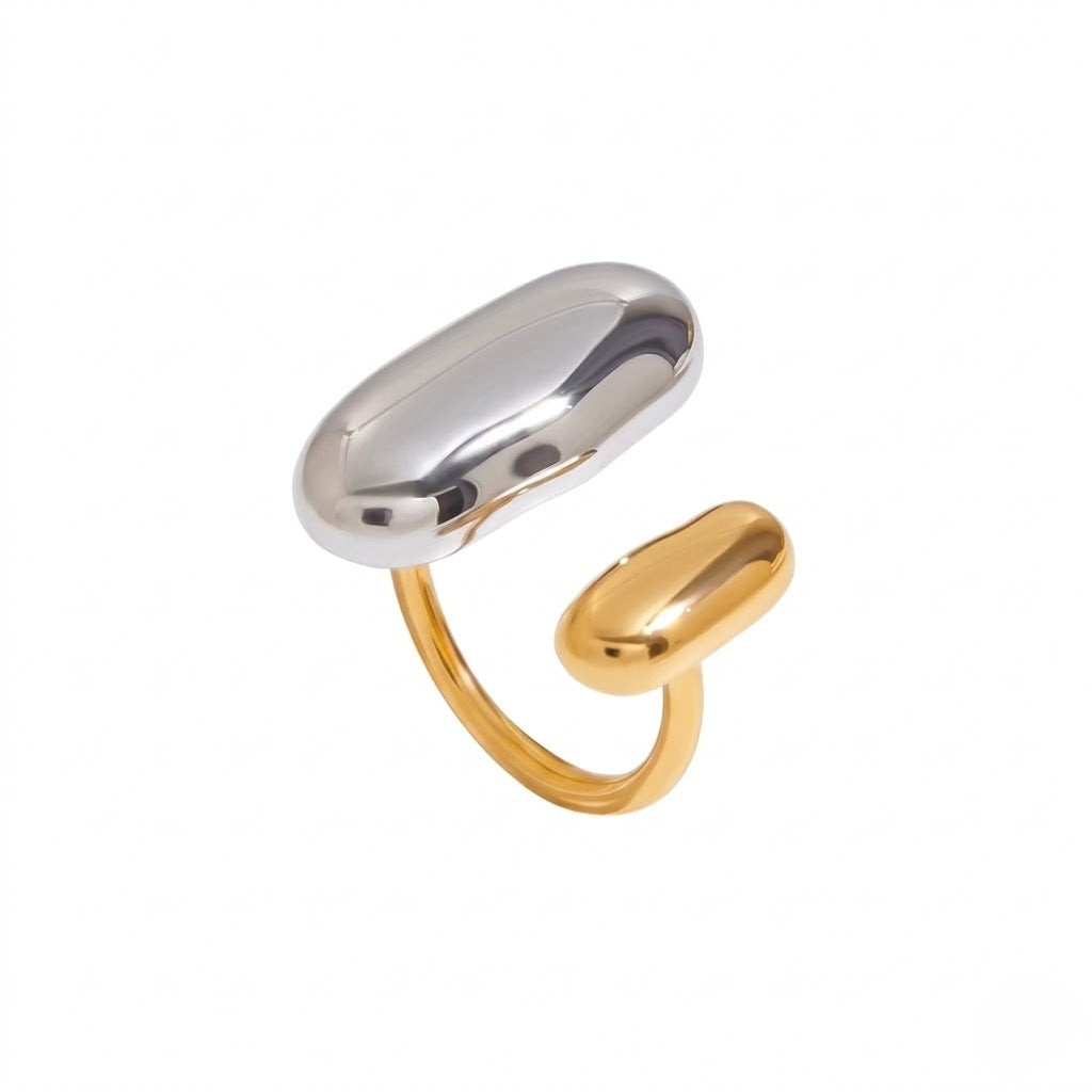 A two-tone metal ring featuring a polished silver-toned oval top and a gold-toned band with a separate small oval end, shown on a plain white background - JCollins Jewelry