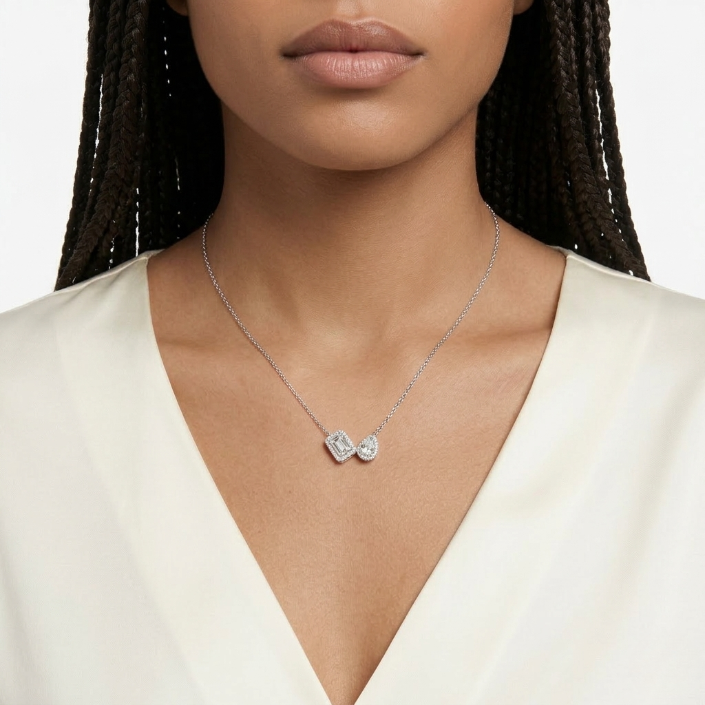Silver Toi et Moi Emerald-Cut and Pear-Cut Diamond Double Halo Pendant Necklace Worn on Female Décolletage - J. Collins Jewelry 