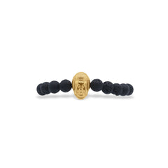 Bracelet with black beads and a gold Buddha head charm on a white background-J.Collins Jewelry