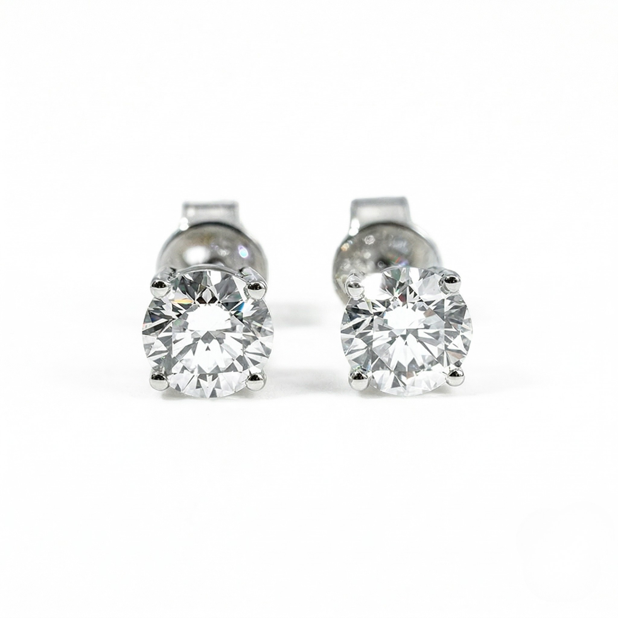 Pair of silver stud earrings with clear gemstones on a white background. - White Gold Diamond Earrings - J. Collins Jewelry 