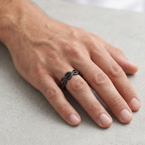 Black Oxidised Pavé Black Diamond Flame Band Ring Worn on Male Hand Against Stone Surface - J. Collins Jewelry 