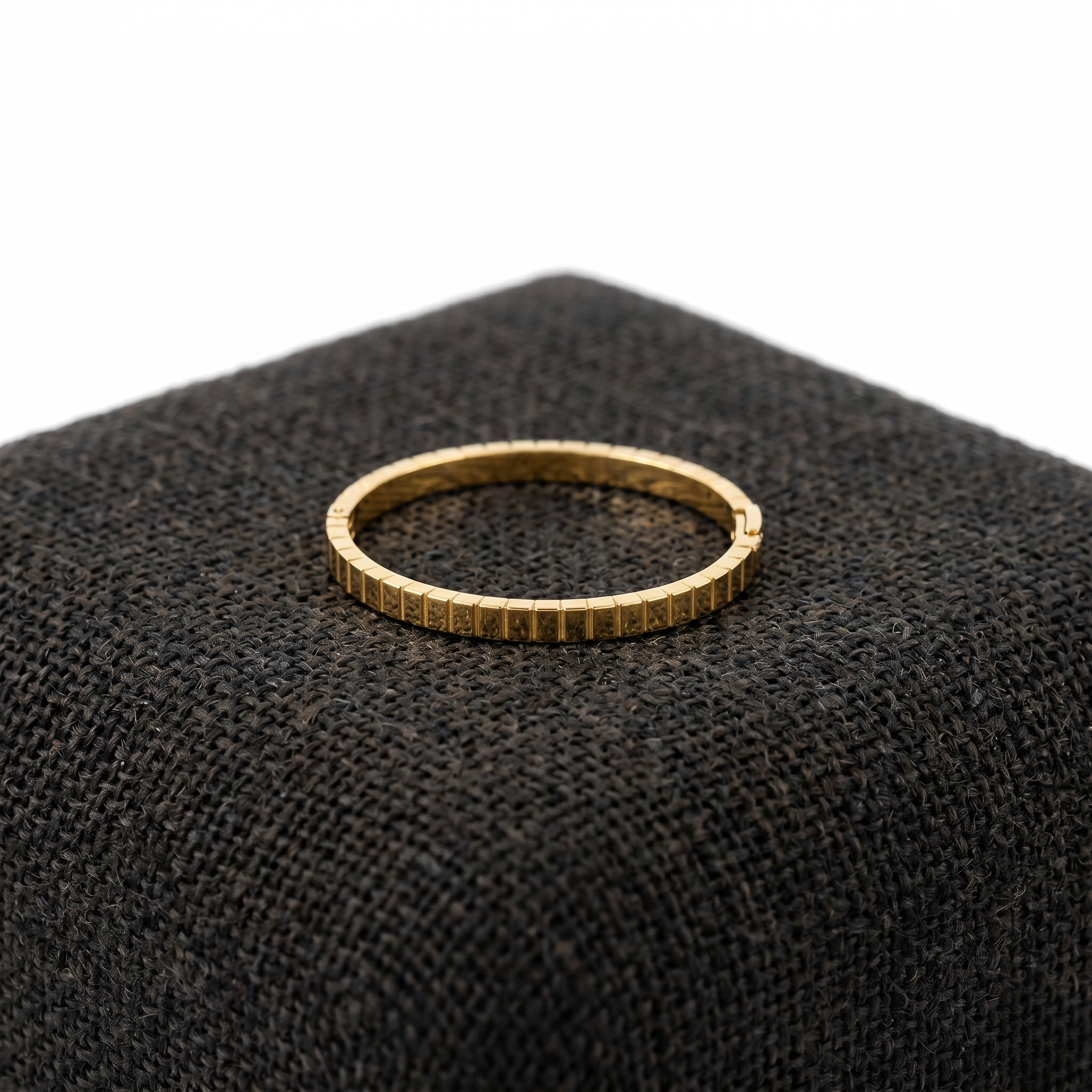 Gold plaid Marcello bangle on dark textured fabric display