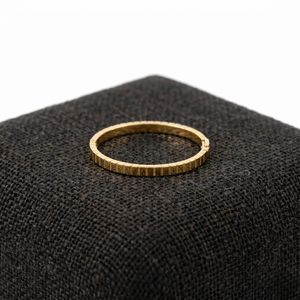 Gold plaid Marcello bangle on dark textured fabric display