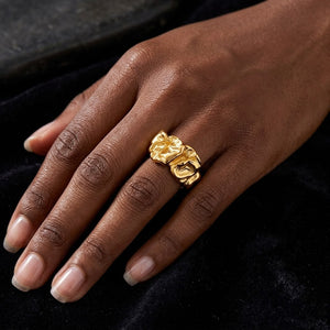 Gold spiral-style Vortex Ring on a hand against a black background.