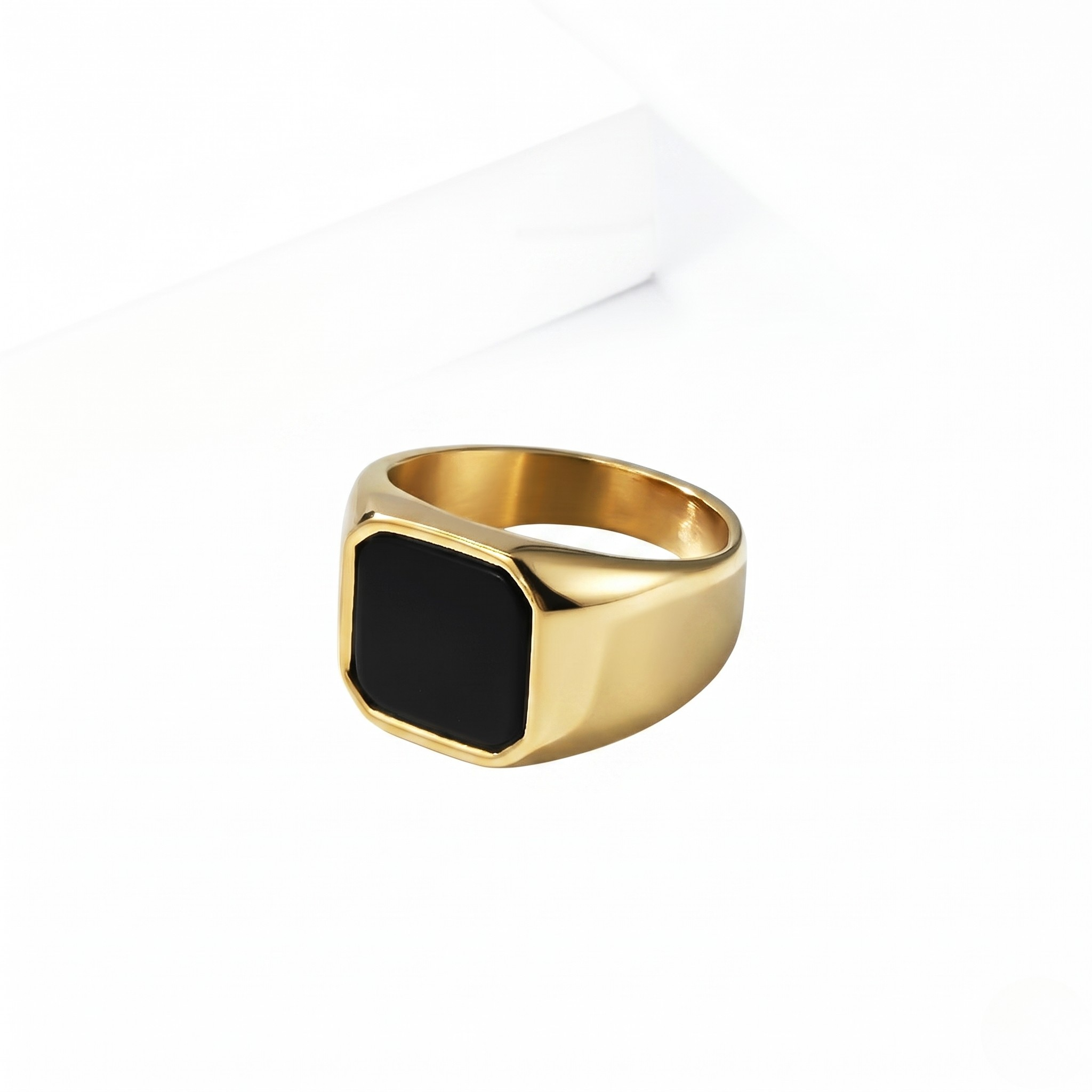 Gold onyx signet ring with square black stone in sleek, modern design
