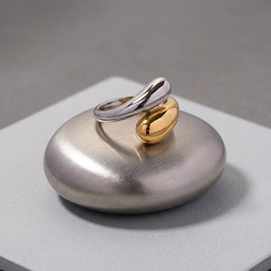 Bicolor ring with gold and silver tones on a brushed metal platform for J.Collins Jewelry.