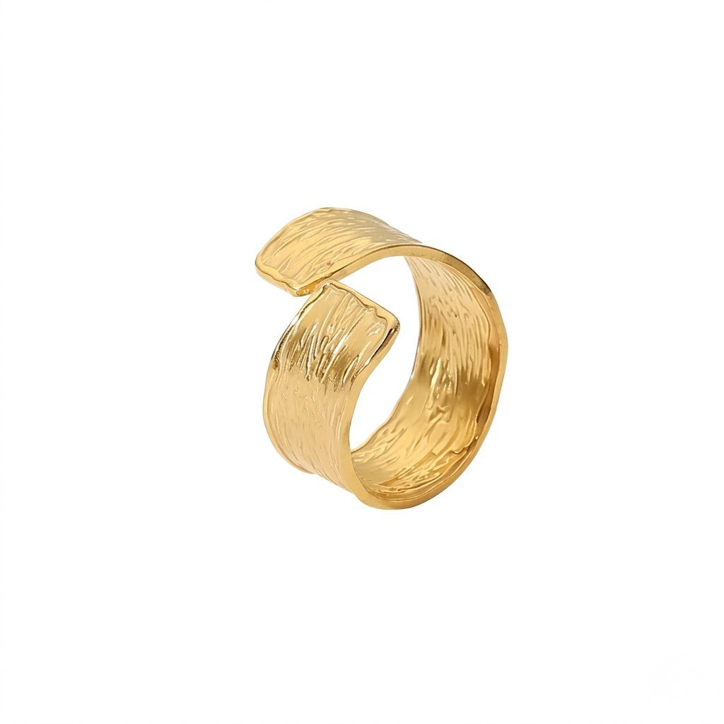Gold textured coil ring on a white background