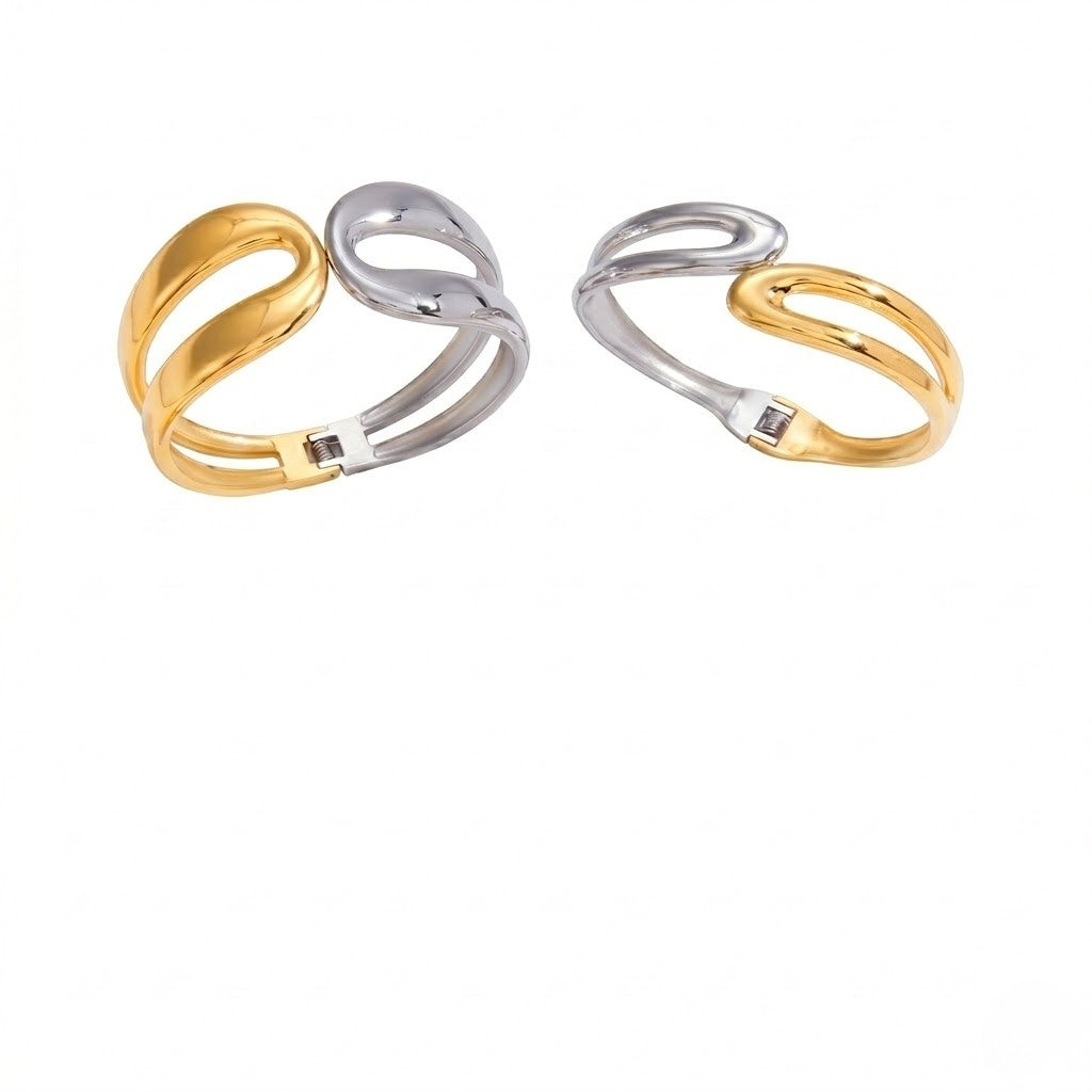 Gold and silver open cuff bracelet with intertwined loop design, modern and elegant style.