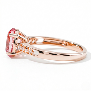18K rose gold ring with lab-created pink gemstone and diamond accents on the band