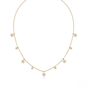 Gold necklace with star and diamond droplet charms, delicate chain style.