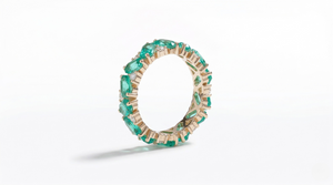 14K yellow gold ring with lab-created emerald stones in a continuous band style