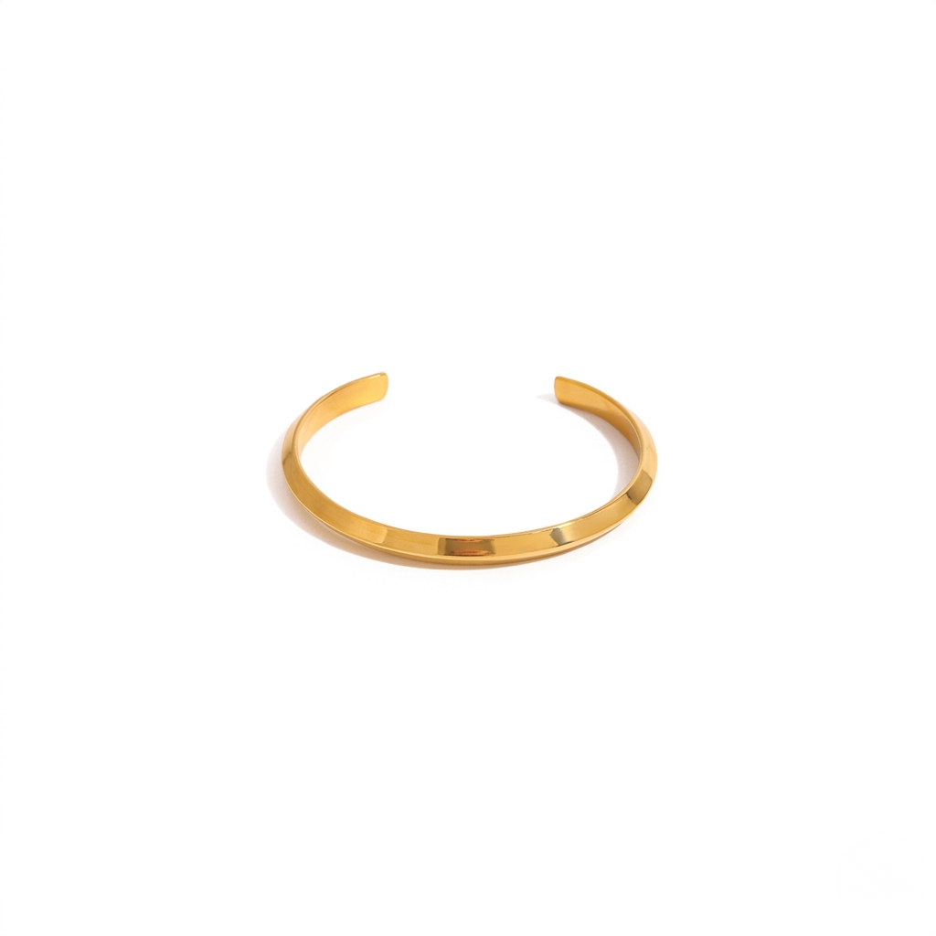 Gold torque cuff bracelet on a white background displaying a sleek, minimalist design