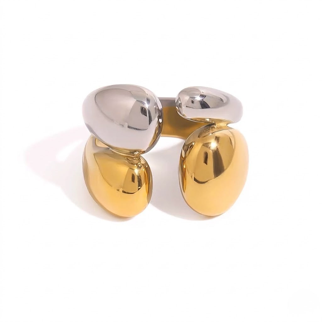 Steel and gold pebble-shaped ring with a modern abstract style on a white background.