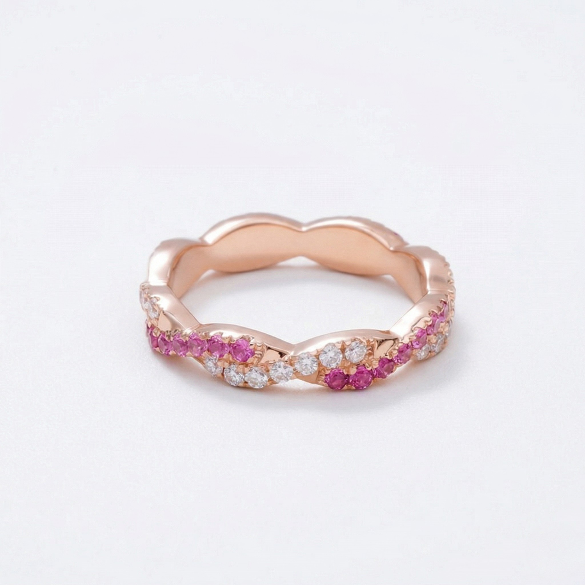 14K rose gold ring with lab-grown rubies and diamonds in a twisted band design