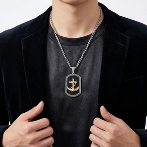 Man wearing J.Collins "The Scout Pendant," featuring a gold anchor on a silver chain, styled with a dark blazer.