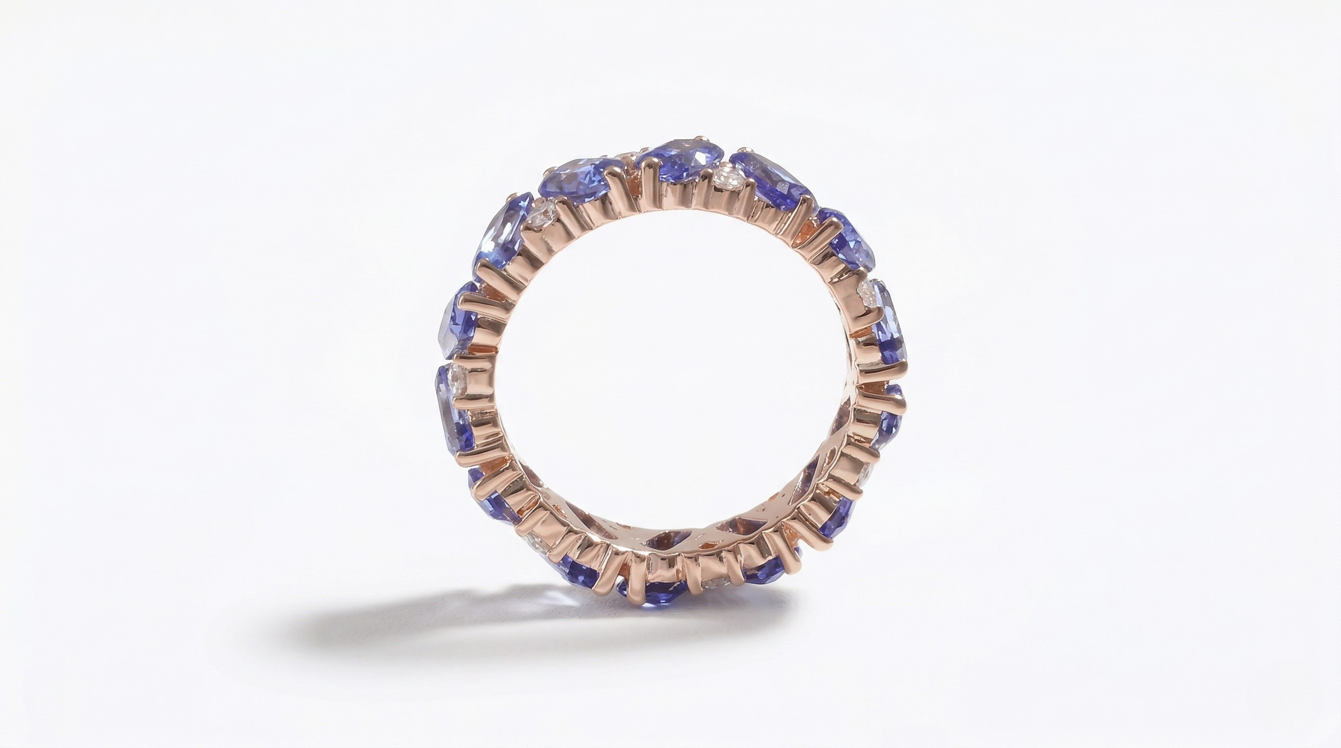 14K rose gold eternity band with round lab-created sapphires