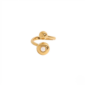 Gold open band ring with pearl accent on one end and a sphere on the other